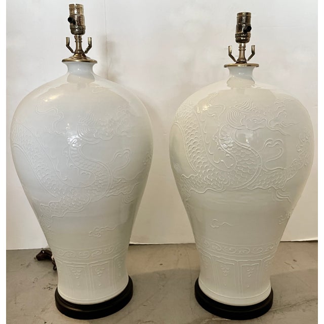 Stunning pair of oversize ceramic table lamps from 80's. Made in Asia, (probably China) with black wood bases and brass...