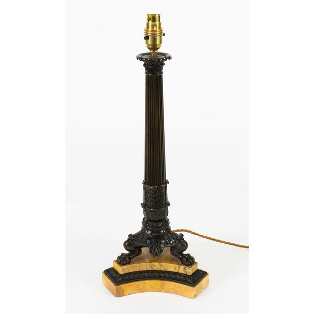 An elegant French Empire bronze and marble table lamp, circa 1820 in date. The candlestick later converted into a lamp...
