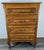 This Vintage French Louis oak chest of drawers features elegant craftsmanship and a refined silhouette. with four drawers...