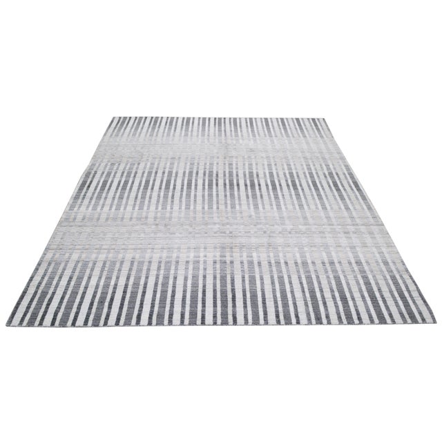 Hand-knotted with care using traditional rug-making techniques, this wool rug blends timeless craftsmanship with a modern...