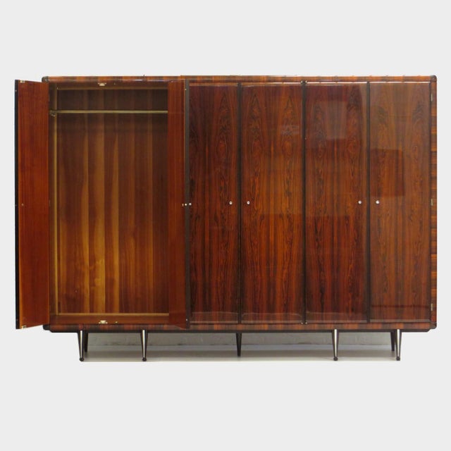 Vintage mid century Italian design wardrobe in rosewood from the 1960s. This unique large 6-door wardrobe is equipped with...