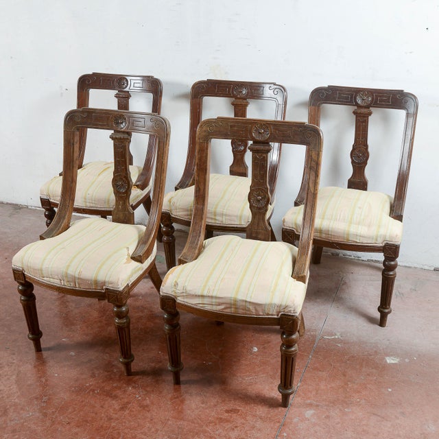This set of five armchairs represents a refined example of classic period cabinetry, ideal for antique enthusiasts seeking...