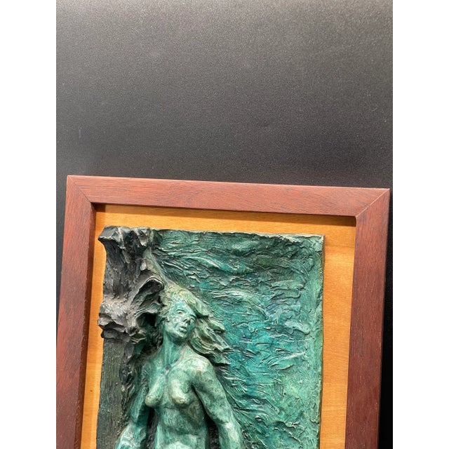 Stunning and one-of-a-kind, this bronze sculpture portrays a captivating nude woman gracefully positioned amidst lush...