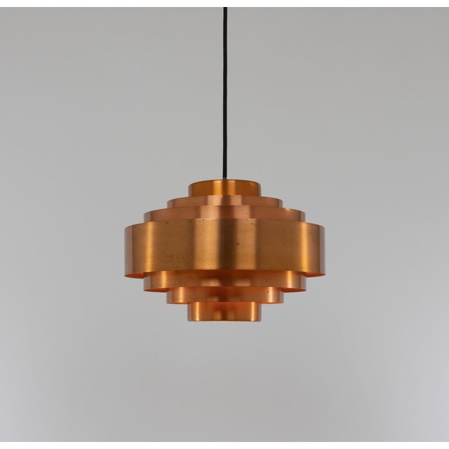 This copper Ultra pendant light was designed by Jo Hammerborg for Fog & Mørup in the very early 1960s. The lamp consists...