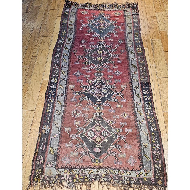 Woven in Eastern Turkey in the early 1900s, this handsome vintage kilim sits at the cultural crossroads of three great...