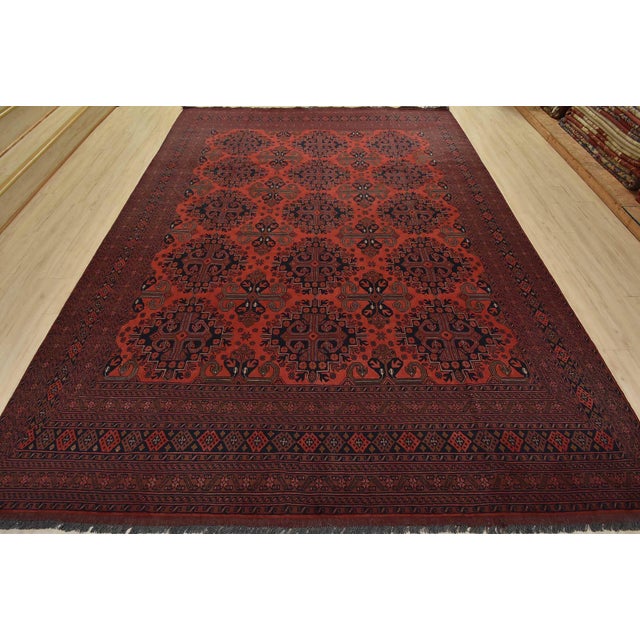 A tribal Turkmen rug hand-knotted with fine wool and natural dyes. This nomadic rug features rows of geometric medallions...