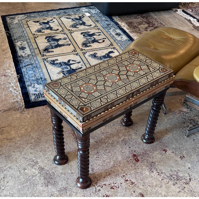 A beautifully crafted vintage marquetry wood inlay with natural mother of pearl folding game table, showcasing intricate...