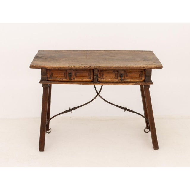 Spanish Baroque Walnut Writing Desk, 17th century, with two drawers on tapered legs with wrought iron scroll supports....