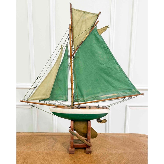 This pond yacht, made in England in the twentieth century, is carved in wood and rigged as a gaff cutter, retaining its...