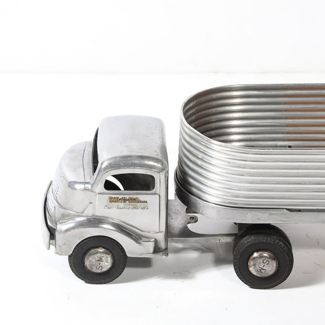 The Smith Miller "Silver Streak" Truck and Trailer, crafted in aluminum in the United States circa 1950, is a shining...