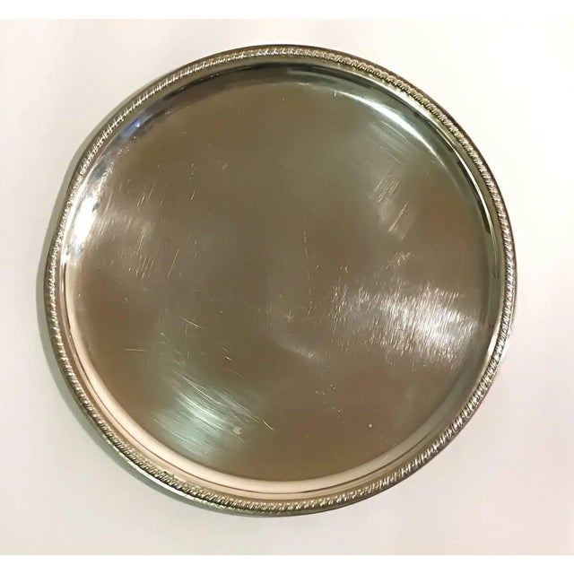 Silver dish nicely decorated on edges. With embroidery. Dent on edge.