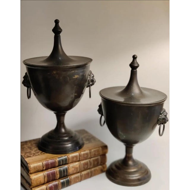 For your consideration . . . A rare vintage pair of gorgeous Chestnut Urns with lion head ring handles. Each urn vase has...
