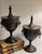 For your consideration . . . A rare vintage pair of gorgeous Chestnut Urns with lion head ring handles. Each urn vase has...
