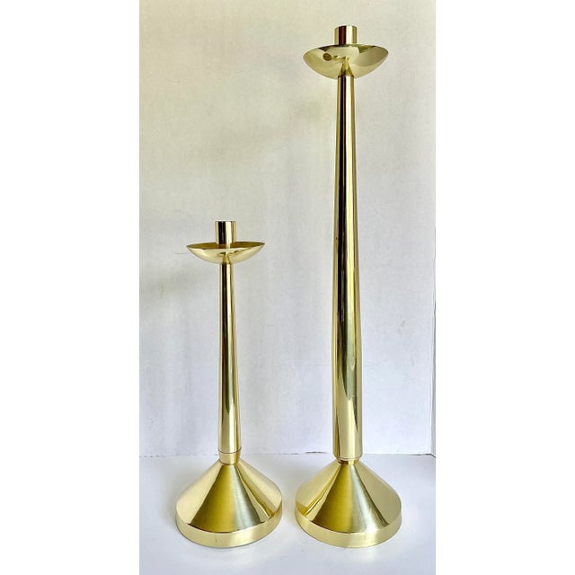 Here is a STUNNING pair of shiny brass candle holder that have a vintage and modern aesthetic! Please note the size, as...