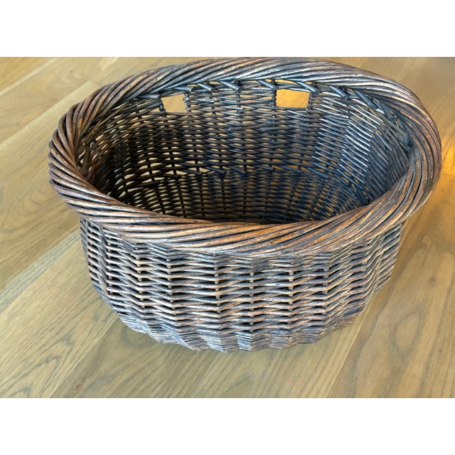 This pair of baskets were made to serve as bicycle baskets. The leather straps that normally attach the basket to the...