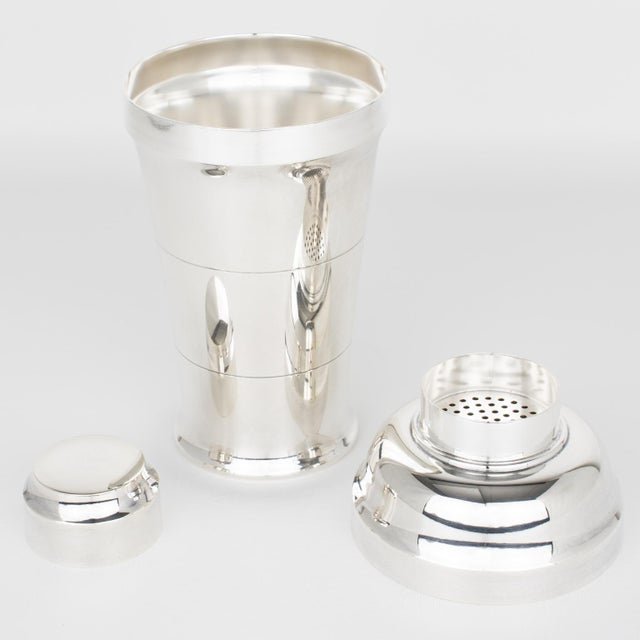 Silversmith Saint Medard, Paris, crafted this stylish Art Deco silver plate cylindrical cocktail or Martini shaker circa...