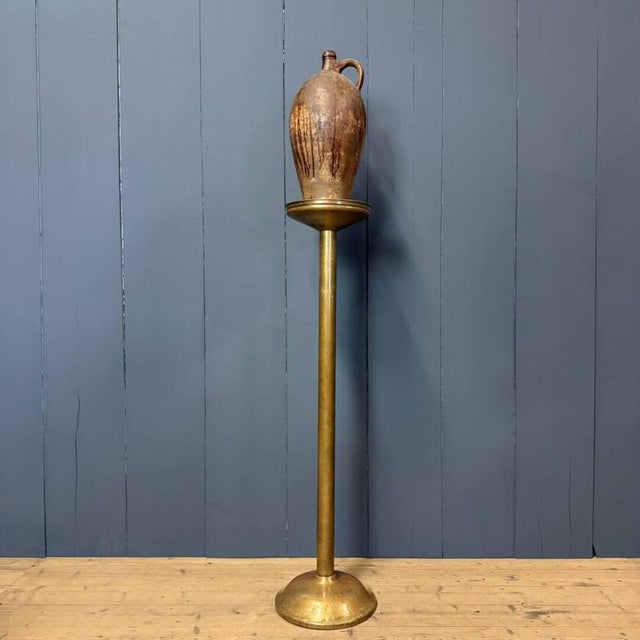 Large brass stand or column originating from a church in the Netherlands, circa 1900. It was used for a candlestick or...