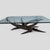 A sculptural cocktail table designed by Silas Seandel in 1972, with a dramatic torch-cut iron base composed as an...