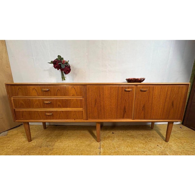 Vintage Teak Sideboard from Turnidge of London, 1960, in Restored conditions. Designed 1960 to 1969 This piece has an...