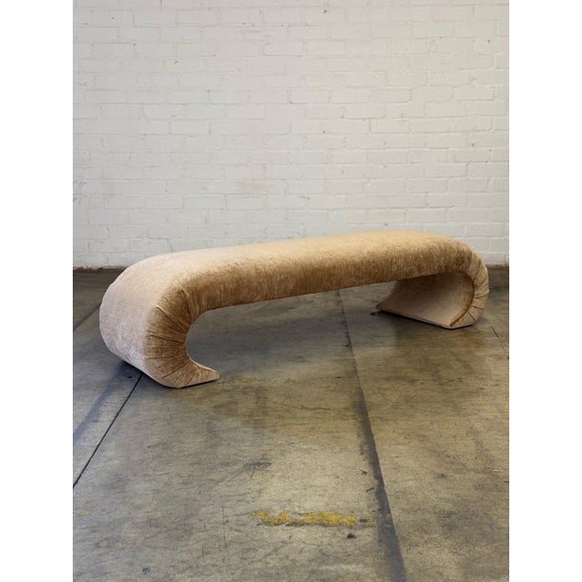 W77 D22.5 H19 Our sleek, sculptural designed waterfall bench upholstered in a soft cognac colored chenille with a subtle...