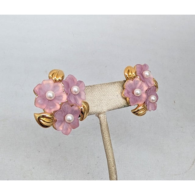 Early 1990s goldtone molded pink resin flowers with faux-pearl centers push back pierced earrings. Marked "NAPIER©" on the...
