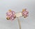 Early 1990s goldtone molded pink resin flowers with faux-pearl centers push back pierced earrings. Marked "NAPIER©" on the...