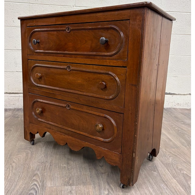 This is a gorgeous antique American Victorian walnut cottage chest of drawers or commode likely dating to the mid-19th...