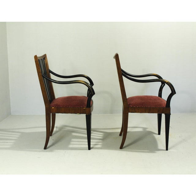 Walnut frame with beech armrests, spring upholstery in very good condition. Black lacquered wood. One chair is missing...