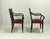 Walnut frame with beech armrests, spring upholstery in very good condition. Black lacquered wood. One chair is missing...