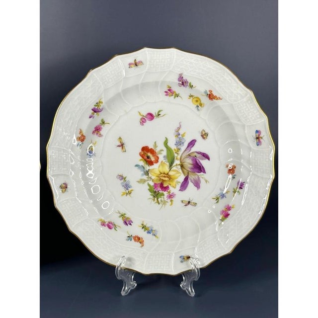Antique Meissen plate, polychr. bouquet of flowers with scattered flowers and insects. Gold rim. "Neubrandenstein"...