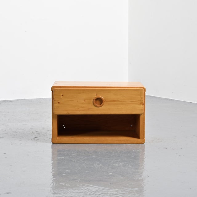 Bedside table with a drawer and circular handle, selected by Charlotte Perriand to furnish the apartments at Les Arcs...