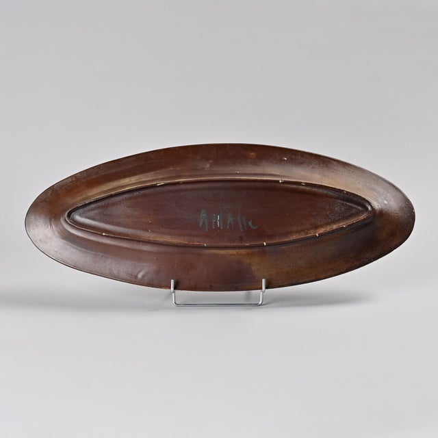 Large ceramic oval platter created by Michel Anasse in France circa 1960. It features a broad rim surrounding an abstract...
