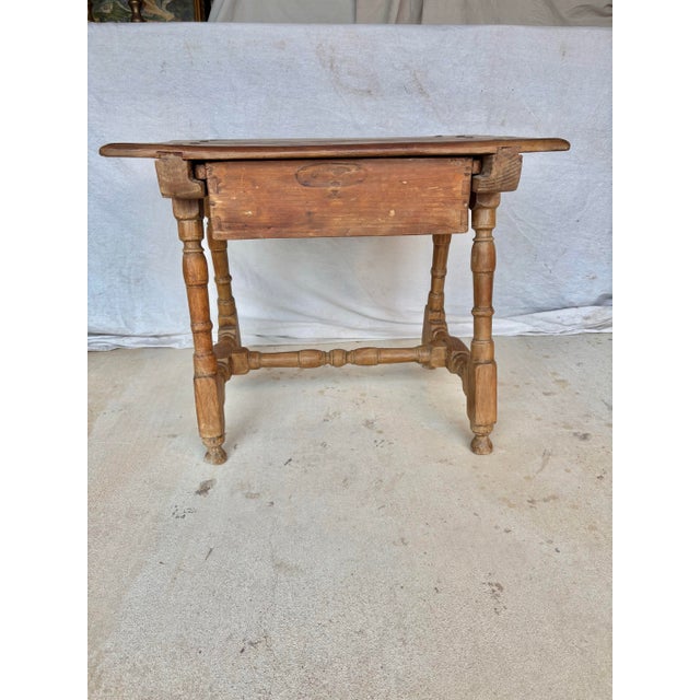 Found in Spain, this Early 20th Century Spanish Side Table was crafted from old growth pine in the early 1900's. The piece...