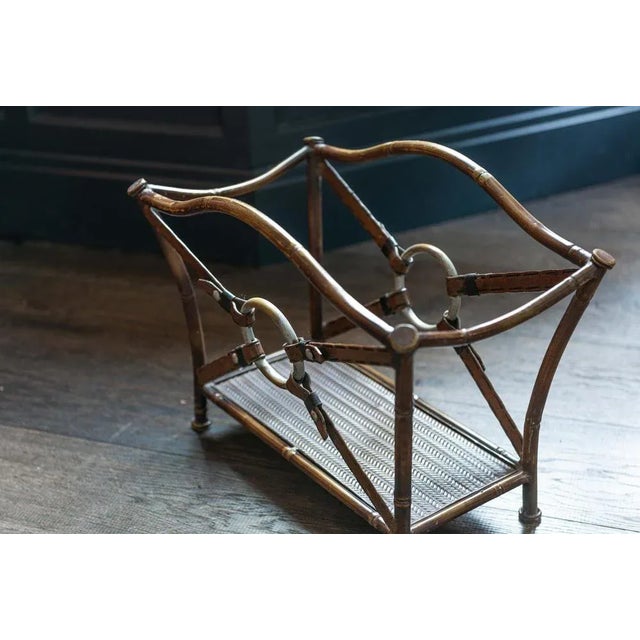 Jacques Adnet style magazine rack, mid-20th century. Mid-Century Modern wrought Iron Faux bamboo and faux painted leather...