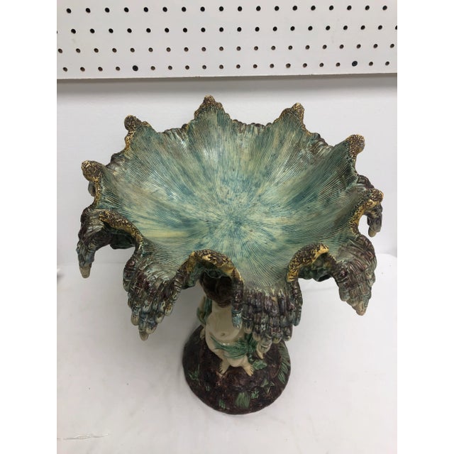 Antique Continental 19th Century Majolica centerpiece with elaborate folded rim bowl on 3 Cherub pedestal.