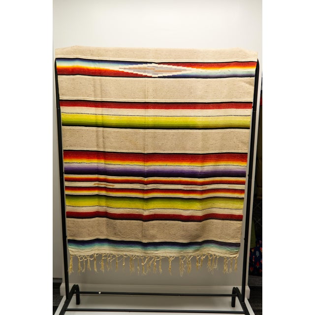 A genuine mid twentieth century hand loomed wool Puebla Saltillo sarape (zarape) blanket. Brightly colored polychrome...