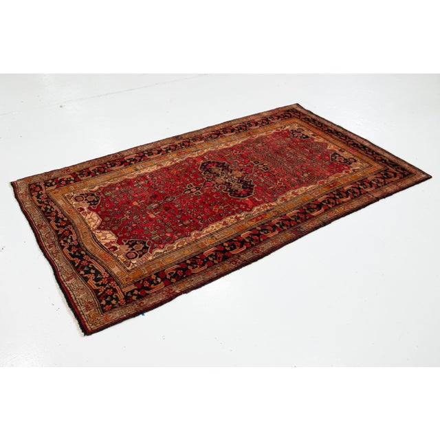 This Persian Bidjar Wool Rug in a rich shade of red, crafted in the 1960s. This exquisite piece showcases the intricate...