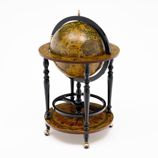 A striking Italian mid-century globe bar cart, circa 1950, combining the romance of Old World cartography with the playful...