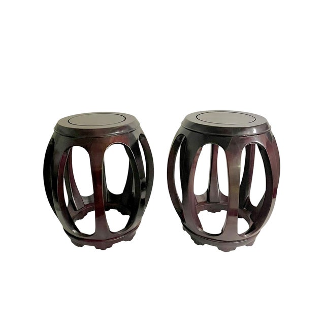 A handsome pair of vintage Chinese hardwood stools featuring an elegant openwork silhouette and rich dark finish. Their...