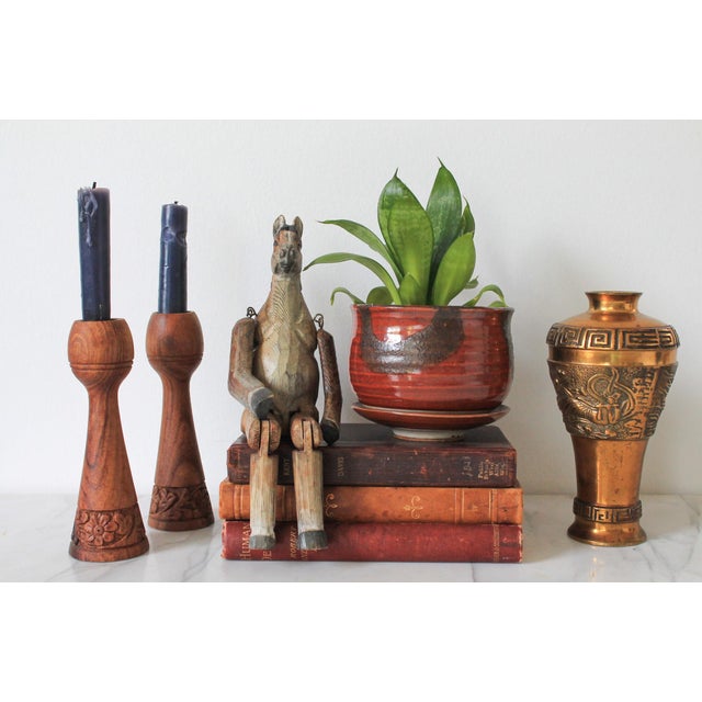 Pair of vintage hand crafted wood candle holders. Made in India. Makers mark on bottom. Minor age wear.