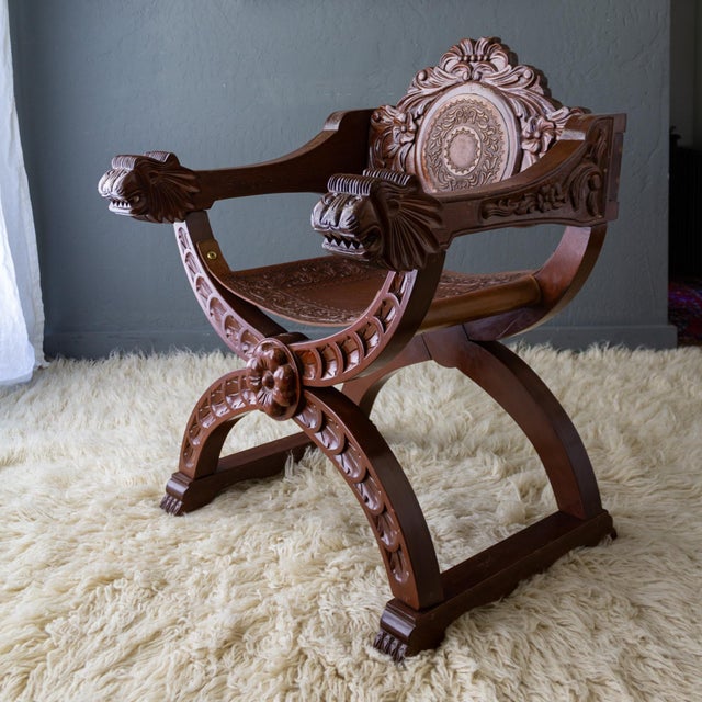 This Spanish Colonial Revival Savonarola chair is hand-carved from tropical Tornillo wood and features a large floral...