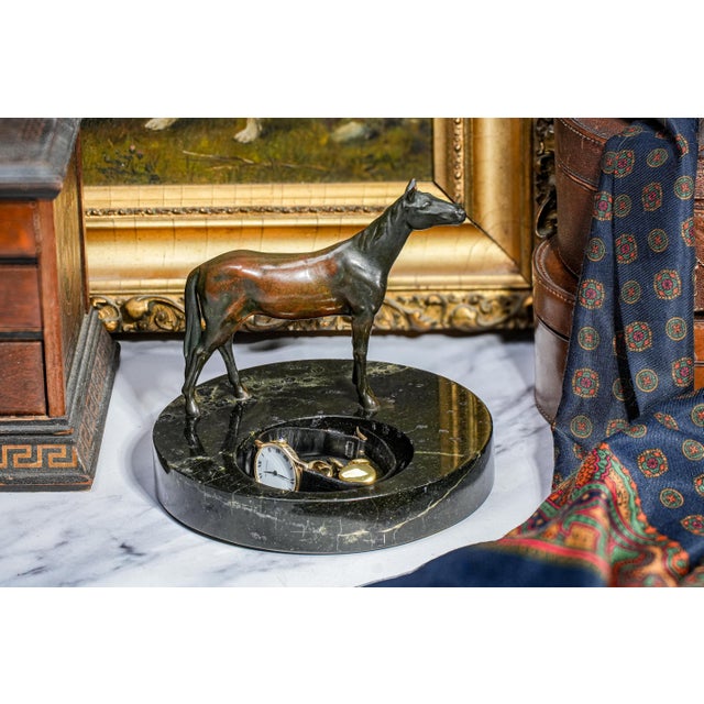 This striking circa 1930 bronze sculpture features a finely modeled standing horse, beautifully capturing the strength,...