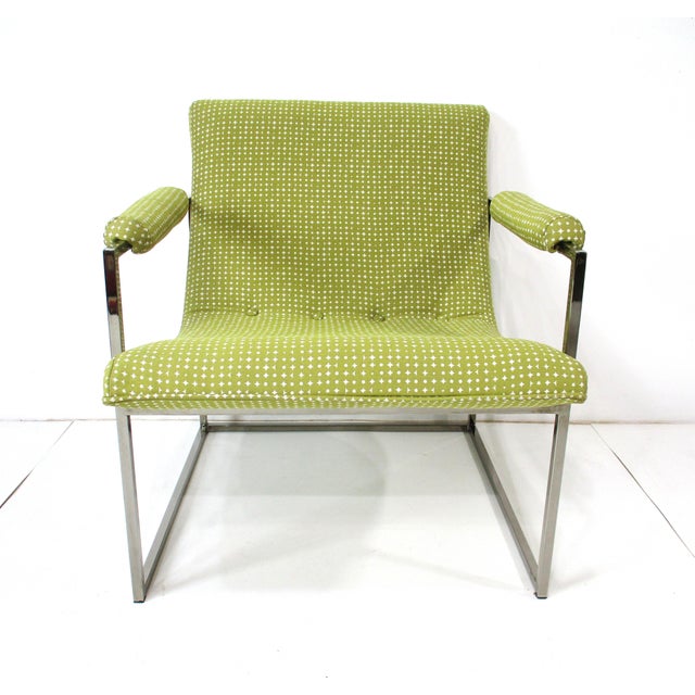 A elegant, chromed steel square tubed based scoop lounge chair in avocado green and off-white patterned upholstery with...