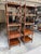 Pretty flamed mahogany étagères with X side detail, decorative medallions and finials in painted wood. A single drawer on...