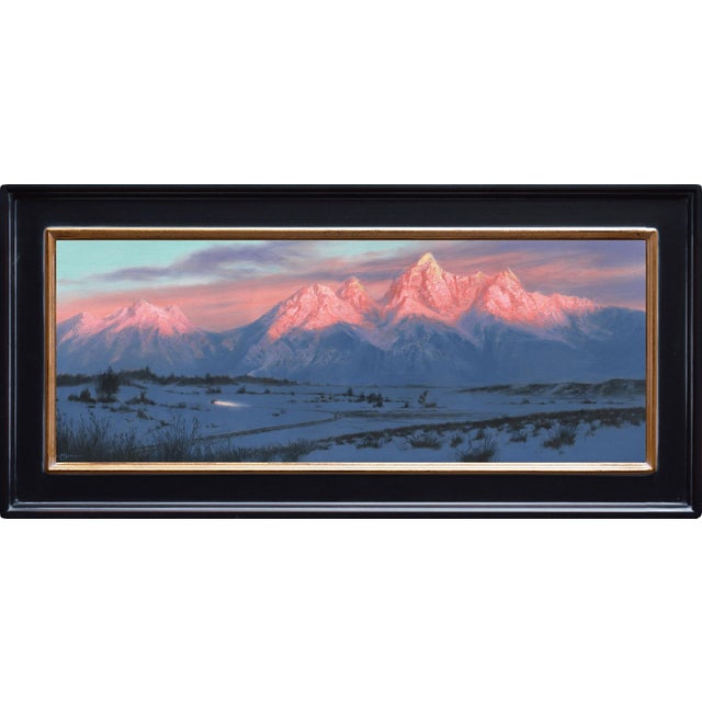 Last Light captures a serene winter landscape at twilight, where the majestic peaks are bathed in warm pink hues,...