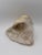 Authentic natural calcite geode featuring a luminous crystalline interior and raw stone exterior. A sculptural mineral...
