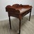 A refined early 19th-century English Georgian writing desk crafted in richly patinated mahogany, featuring a shaped three-...