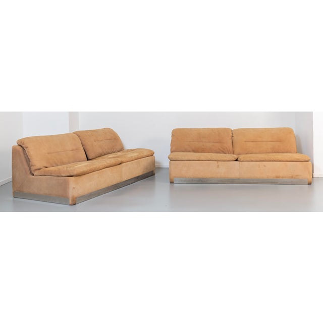 Wooden frame, padding, and cushions covered in suede. Manufacturer's labels. This piece has an attribution mark, I am sure...