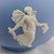 This is a Wedgwood light blue Jasperware sugar bowl with lid. The bowl has a white design of women in assorted dresses....