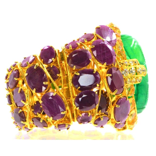 Gold-tone Iradj Moini cuff bracelet featuring carved emerald, ruby, citrine and crystal at openwork motif and high polish...